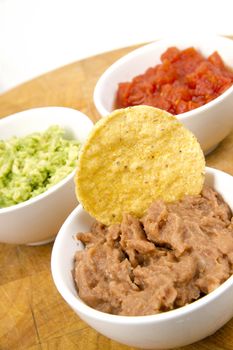 Food Appetizers Chips and Salsa Refried Beans Guacamole on Wood Cutting Board