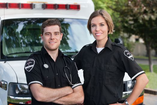 Paramedic team portrait standing in front of ambulance