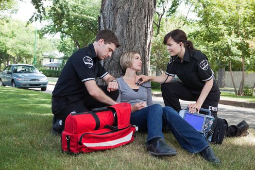 Emergency medical professionals assessing an injured patient on the street