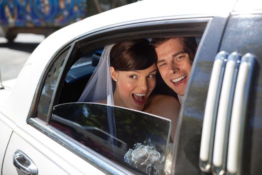 Newly weds laughing in car