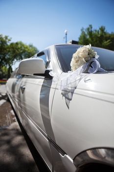 Luxury wedding car with rose flower bouquet