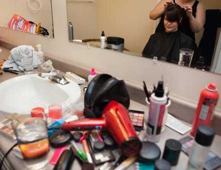 Bride having hair done at home before wedding