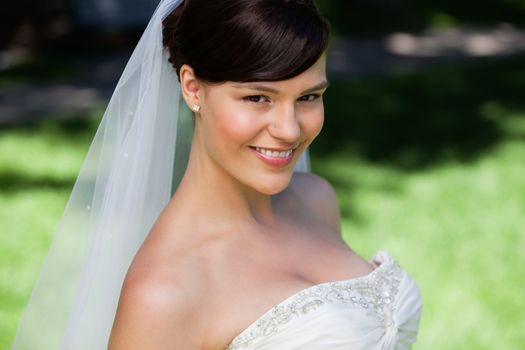 Close-up portrait of a pretty young bride smiling