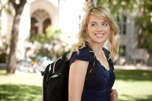 Pretty blond university student looking over shoulder