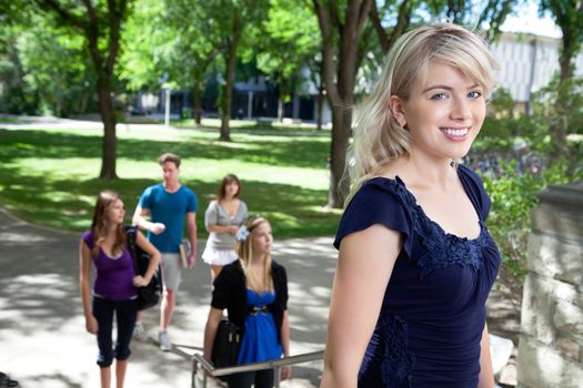 Portrait of college girl going college with friends in background