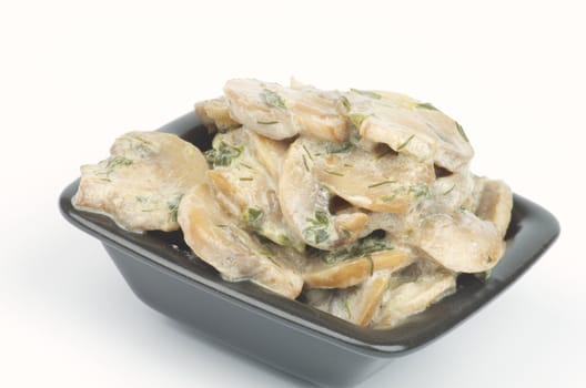 Julienne with Mushrooms, Sour Cream and Greens in Square Black Bowl isolated on white background