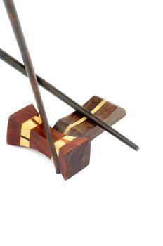 Pair of Handmade Brown Chopsticks and Hasioki Cross Section on white background