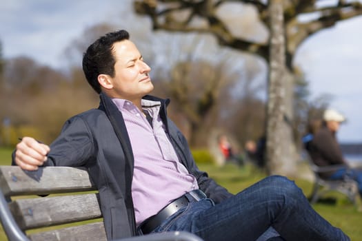 An image of a relaxing man in the sun