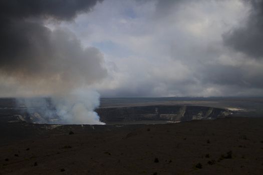 Steaming hole of the kilauea volcano during a cloudy day