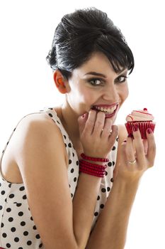 young woman bitting her finger and holding a velvet cupcake