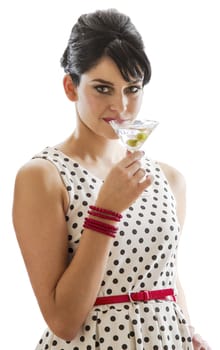 young woman with retro look taking a sip from a martini drink