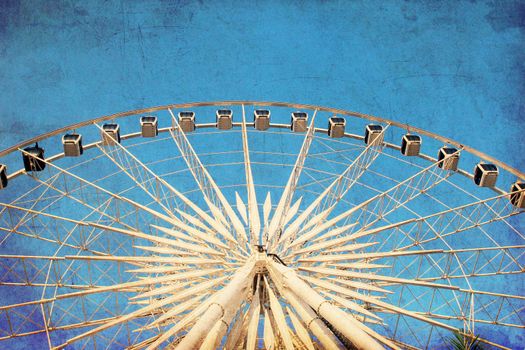 Ferris wheel with blue sky, photo in old image style