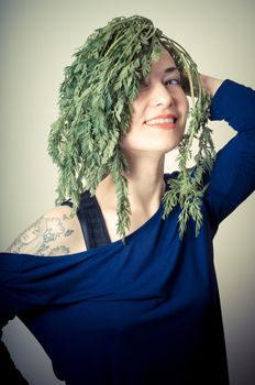 beautiful woman with carrots on hair on gray background