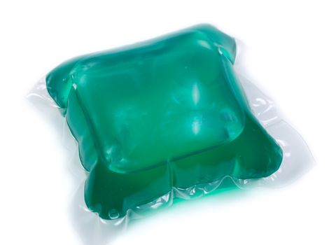 Green gel laundry capsules. Isolated on white background