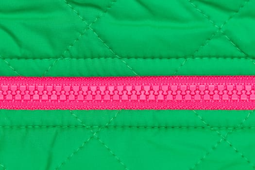 pink zipper on the green quilted fabric