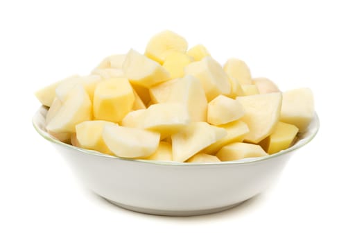 plate with peeled potatoes cut into pieces. Isolate on white