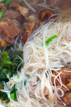 Thai noodle soup and pork meat closeup