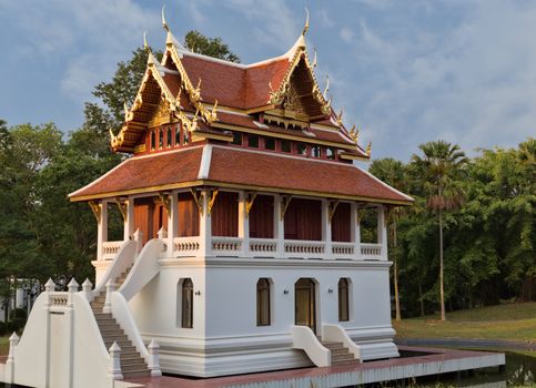 beautiful little Thai temple in the forest setting sun