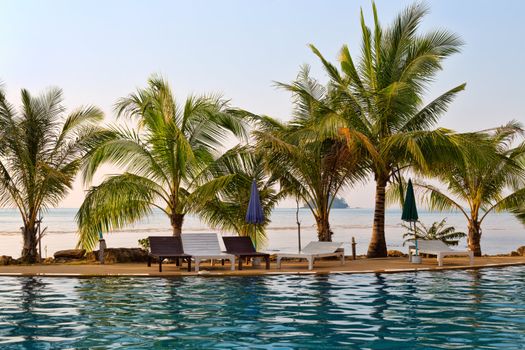 swimming pool, palm trees against the sea on the island of Koh Chang in Thailand