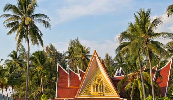 Traditional Thai house with palm trees, Thailand
