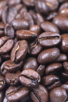 Close-up (macro) shot of coffee beans, filling the frame. Shallow depth of field.