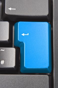 Close up (macro) shot of the 'Enter' aka 'Return' key on a black computer keyboard.  Coloured blue with original word removed.