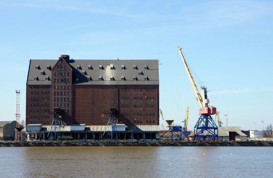 Port granary on a background of the blue sky