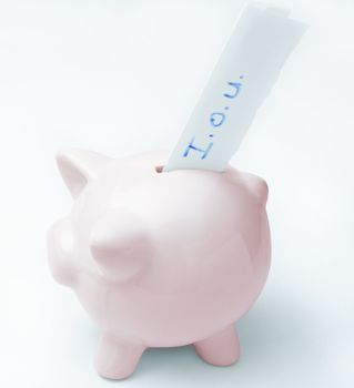 A pink piggy bank with an I.O.U. slip protruding from it's slot, to signify that it has been emptied and the owner cannot refill it.