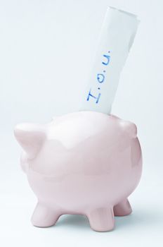 A pink piggy bank with an I.O.U. slip protruding from it's slot, to signify that it has been emptied and cannot be refilled.