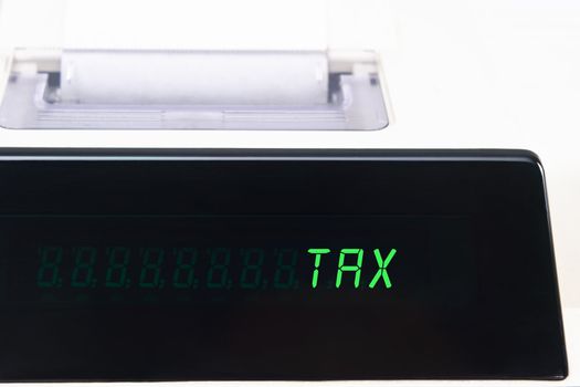 Close up of an LED calculator screen, displaying the word TAX in capital letters.