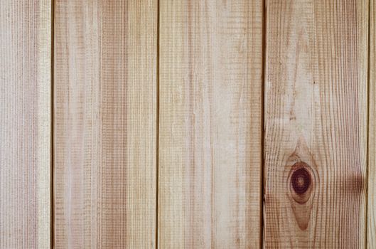 A light wood, pine planked background texture with planks running vertically.