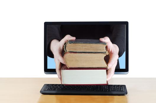 Arms reaching through computer screen holding a stack of three vintage books. Conceptual composite shot to illustrate online delivery of books, knowledge or education.
