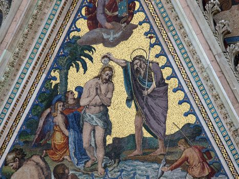 Orvieto - Duomo Facade. The biblical scene of Jesus baptism, a mosaic of the left portal of the cathedral