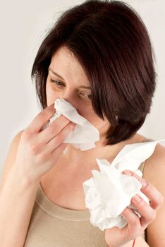 sneezing woman holding tissues, allergy or cold flu concept