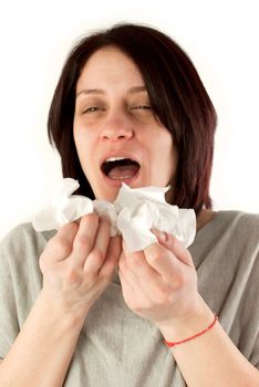 motion blur image of sneezing woman holding tissues, allergy or cold flu concept
