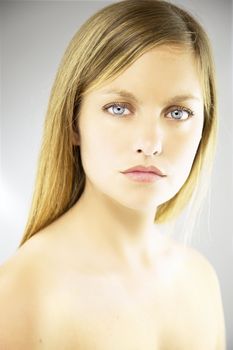 Sad gorgeous blond young woman portrait in studio beauty shot