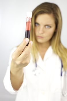 Good looking blond female doctor ready to do test on blood sample