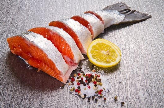 slice of fresh salmon with lemon , salt and pepper