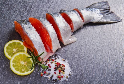 slice of fresh salmon with lemon , salt and pepper