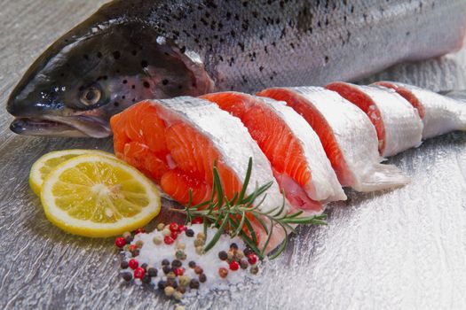 slice of fresh salmon with lemon , salt and pepper