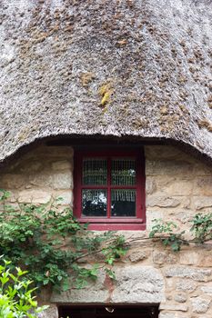 Front of a thatched cottage in Brittany (France)