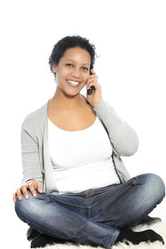 Sitting woman smiling while calling through her cellular phone