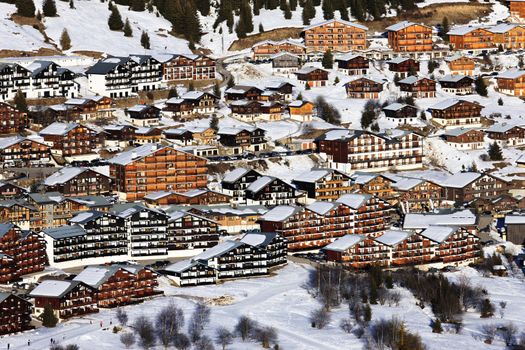 alpine village with chalets in winter, France