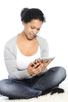 Sitting woman playing and browsing through her tablet-pc