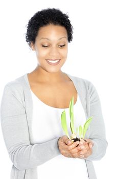 African American young woman hollding a plant, looking down, on white background