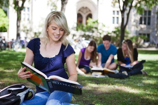 Students reading books in college campus