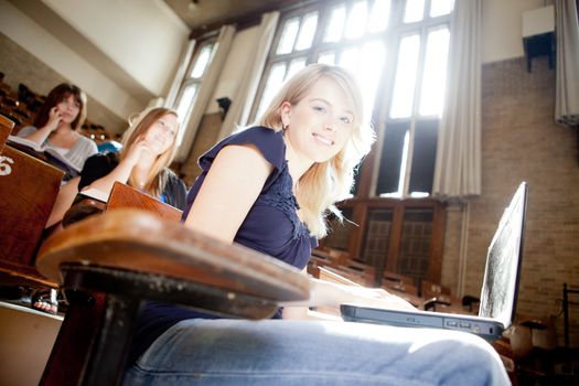 Students in a lecture hall with strong backlighting