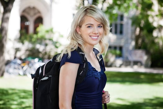 Portrait of sweet smiling college girl with backpack