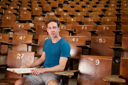 Portrait of a young university student sitting in a lecture hall