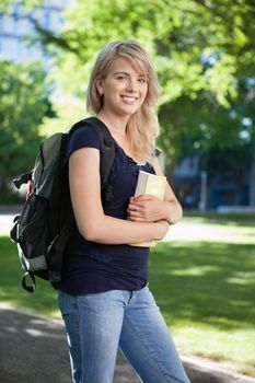 Portrait of a college student with book and bag